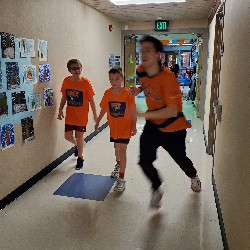 Apex team member with students running